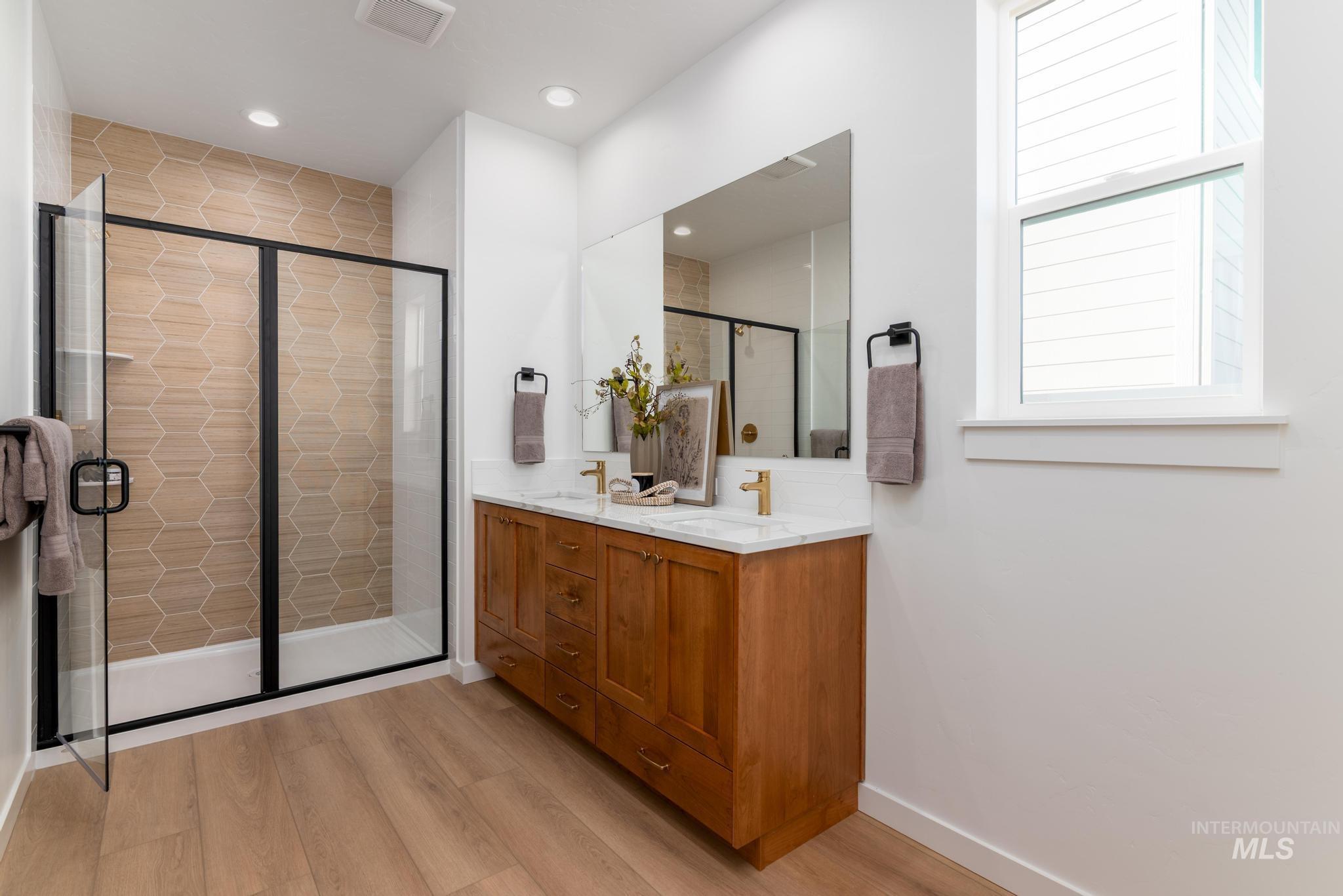 14803 Wing Spread Drive Caldwell, ID 83607 - Photo 7 of 8 Bathroom with double vanity, light wood-type flooring, a stall shower, and recessed lighting