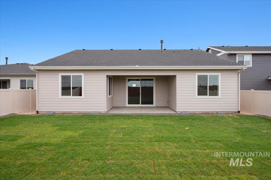 14803 Wing Spread Drive Caldwell, ID 83607 - Photo 8 of 8 Rear view of house featuring a fenced backyard, a patio, crawl space, and roof with shingles