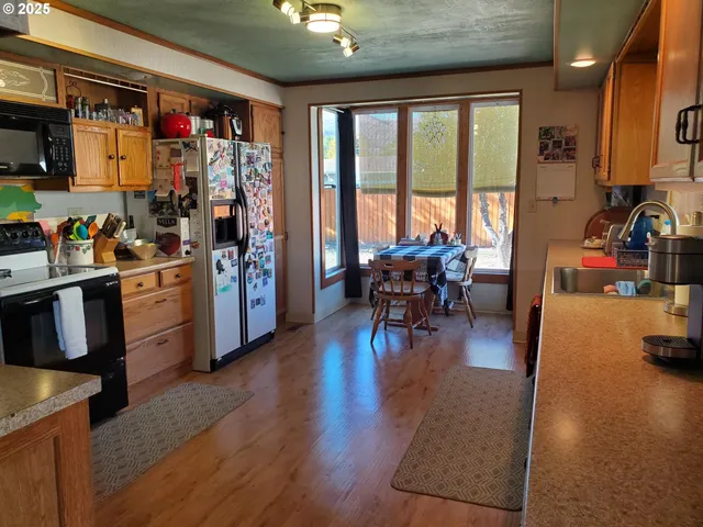 a view of a dining room with furniture water view and a kitchen