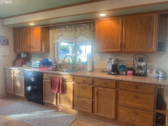 a kitchen with cabinets a sink and appliances