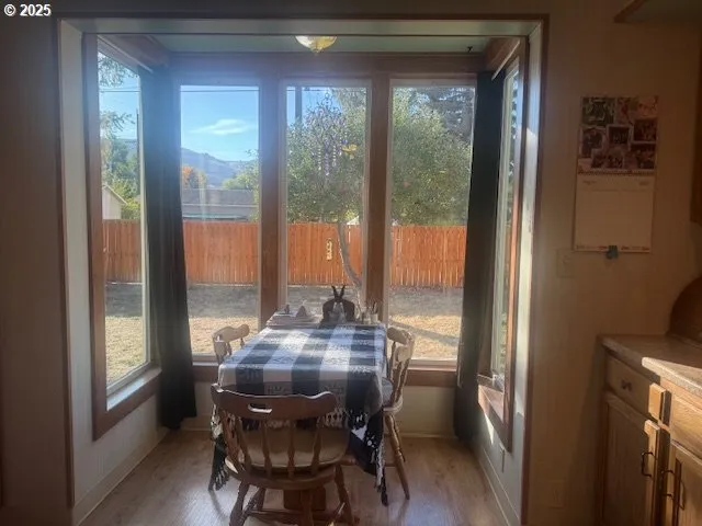 a view of a dining room with furniture and window