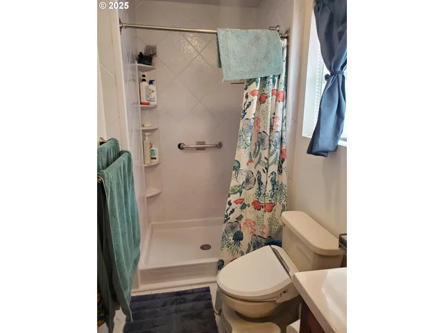 a bathroom with a toilet and a shower