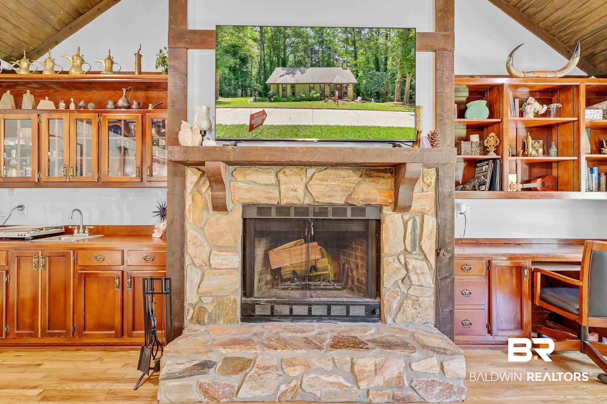 332 Ridgewood Drive Daphne, AL 36526 - Photo 14 of 48 Detailed view of wood finished floors, wooden ceiling, and a stone fireplace