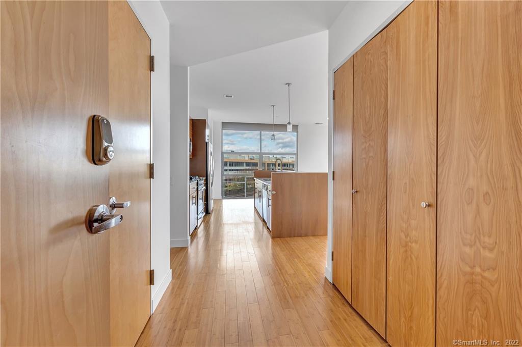 33 North Water Street, Unit 607 Norwalk, CT 06854 - Photo 12 of 40 a view of a hallway with wooden floor and cabinet