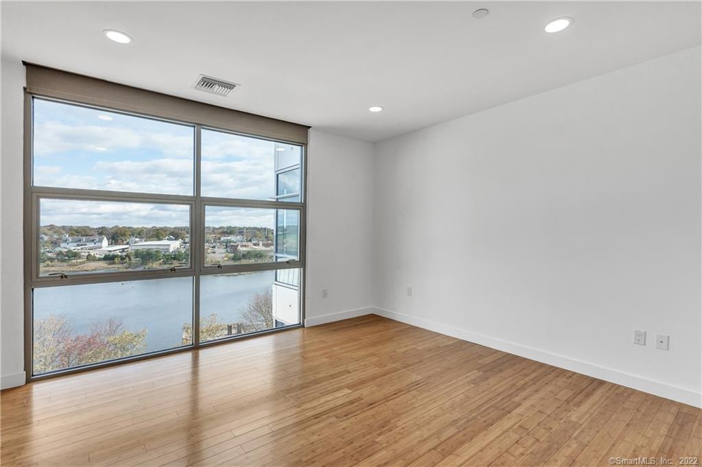 33 North Water Street, Unit 607 Norwalk, CT 06854 - Photo 14 of 40 a view of an empty room with wooden floor and a window