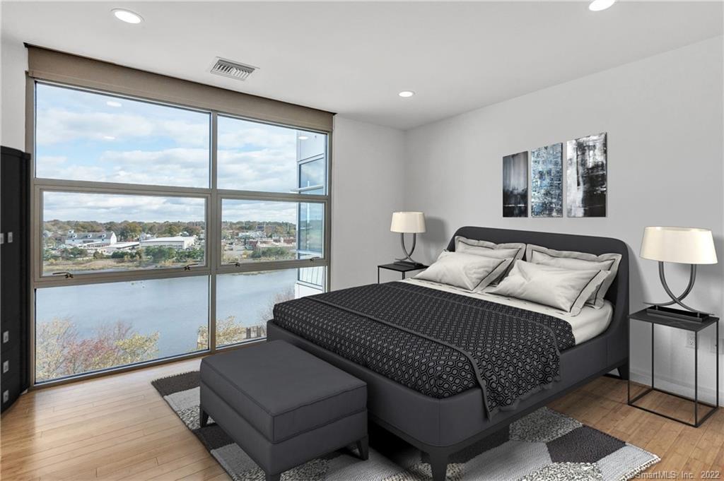 33 North Water Street, Unit 607 Norwalk, CT 06854 - Photo 15 of 40 a bedroom with a bed and a large window