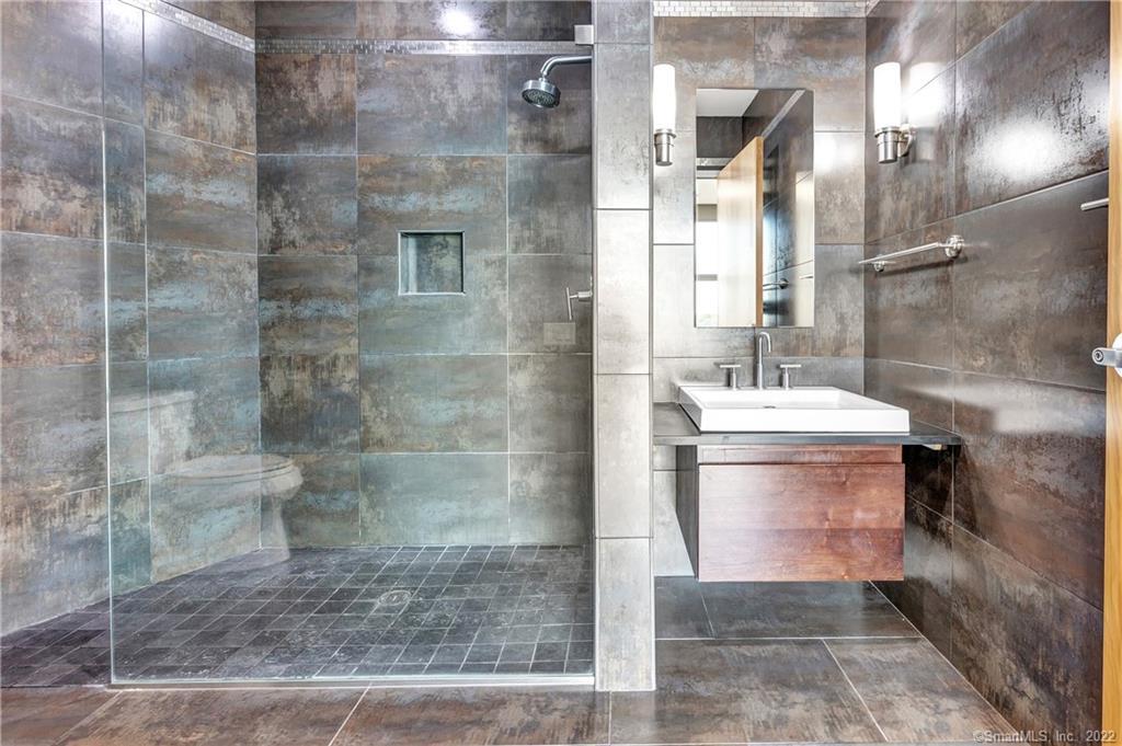 33 North Water Street, Unit 607 Norwalk, CT 06854 - Photo 18 of 40 a bathroom with a mirror and a shower