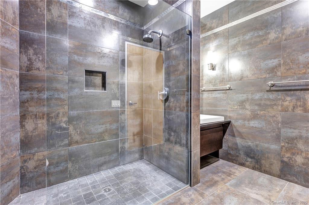 33 North Water Street, Unit 607 Norwalk, CT 06854 - Photo 19 of 40 a bathroom with a shower and mirror