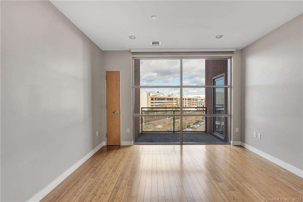33 North Water Street, Unit 607 Norwalk, CT 06854 - Photo 20 of 40 wooden floor in an empty room with a window