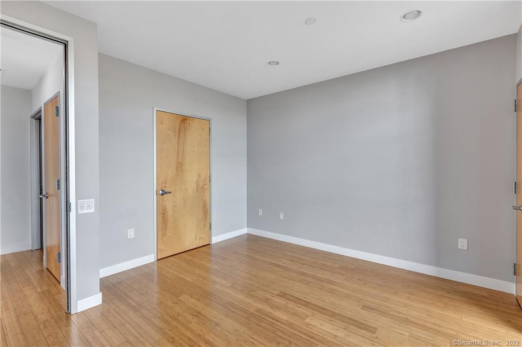 33 North Water Street, Unit 607 Norwalk, CT 06854 - Photo 21 of 40 a view of an empty room with wooden floor and a window