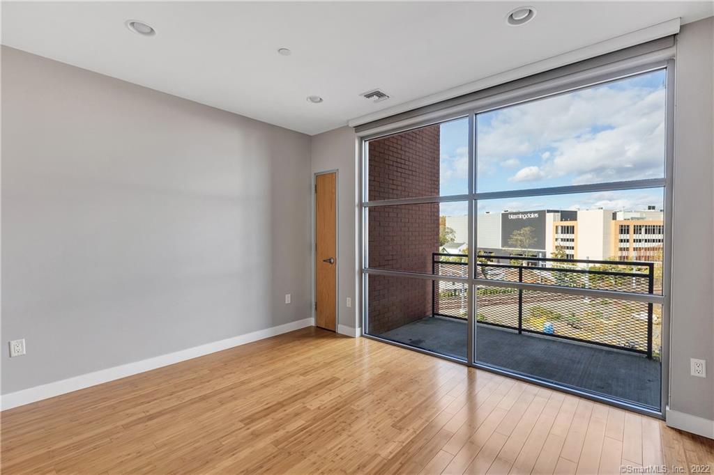 33 North Water Street, Unit 607 Norwalk, CT 06854 - Photo 22 of 40 a view of empty room with wooden floor and floor to ceiling window