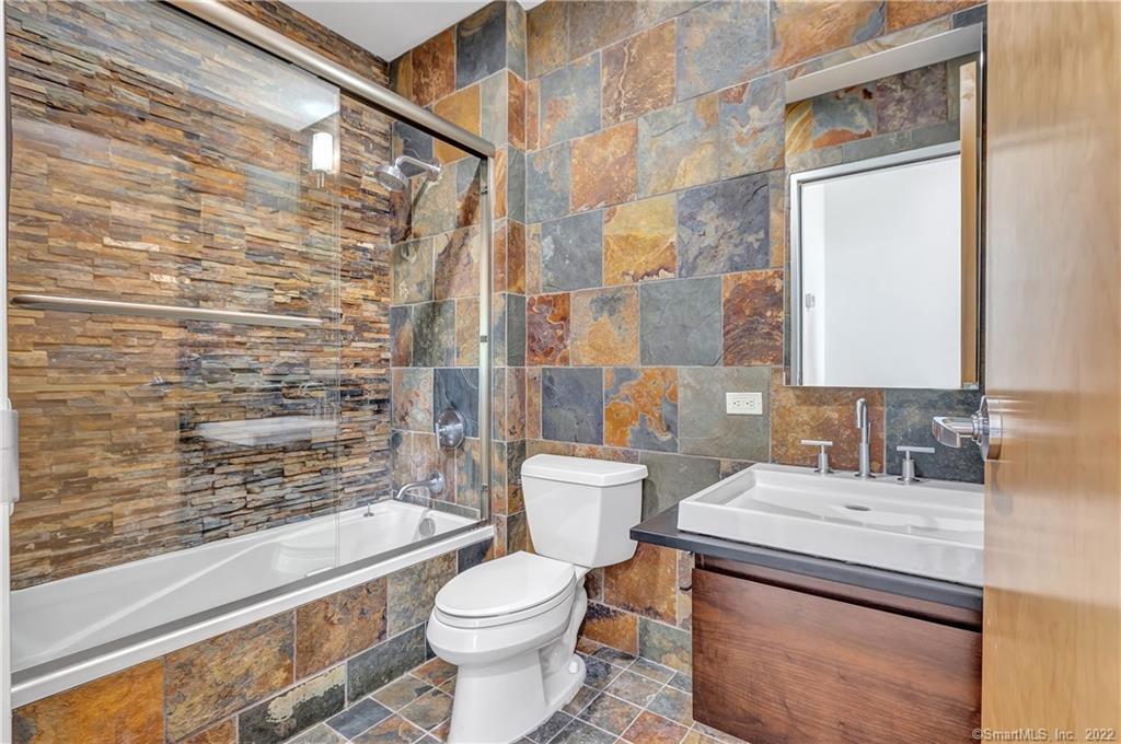 33 North Water Street, Unit 607 Norwalk, CT 06854 - Photo 24 of 40 a bathroom with a sink a toilet and shower