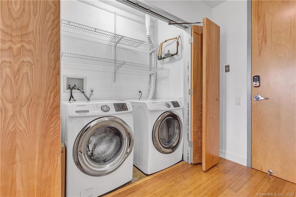 33 North Water Street, Unit 607 Norwalk, CT 06854 - Photo 25 of 40 a view of a hallway with washer and dryer