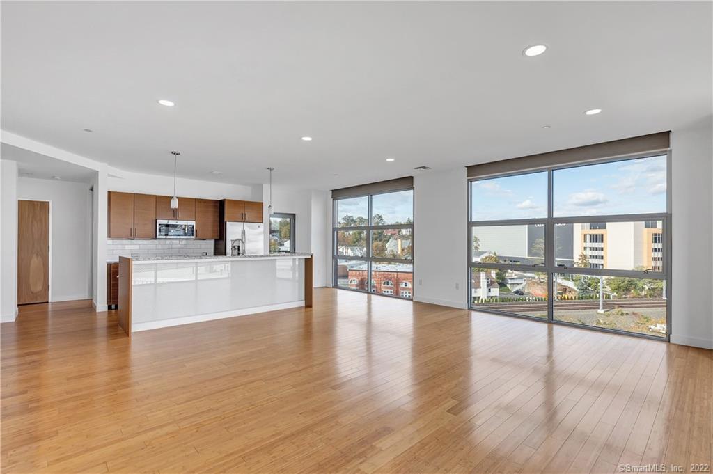 33 North Water Street, Unit 607 Norwalk, CT 06854 - Photo 9 of 40 a view of an entryway with wooden floor and windows