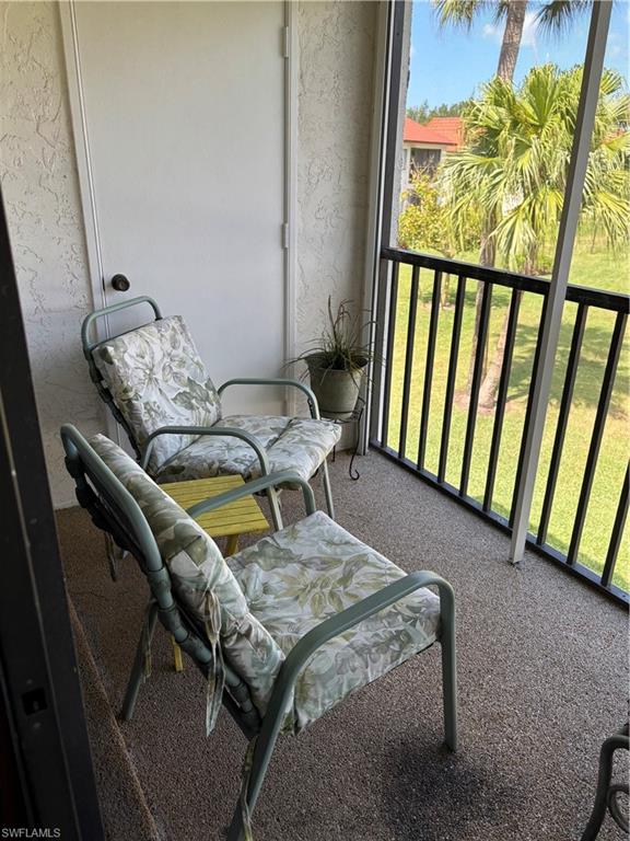4983 Pepper Circle, Unit H201 Naples, FL 34113 - Photo 11 of 17 a balcony view with a table and chairs
