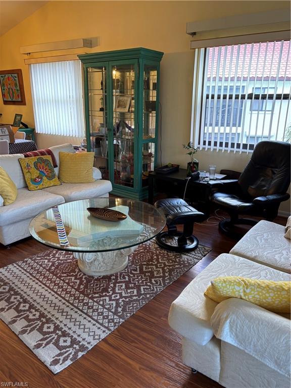 4983 Pepper Circle, Unit H201 Naples, FL 34113 - Photo 16 of 17 a living room with furniture and a large window
