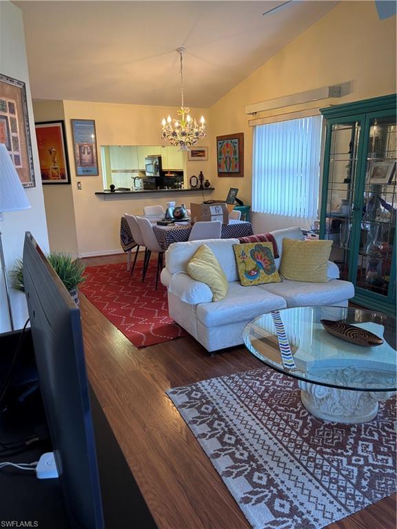 4983 Pepper Circle, Unit H201 Naples, FL 34113 - Photo 3 of 17 a living room with furniture and a chandelier