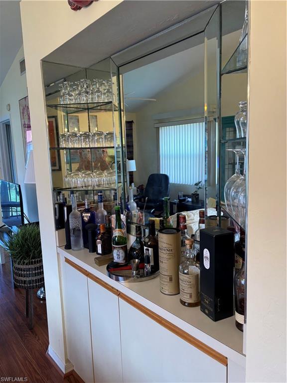 4983 Pepper Circle, Unit H201 Naples, FL 34113 - Photo 6 of 17 a kitchen with a sink and a refrigerator