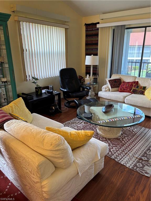 4983 Pepper Circle, Unit H201 Naples, FL 34113 - Photo 8 of 17 a living room with furniture and a fireplace