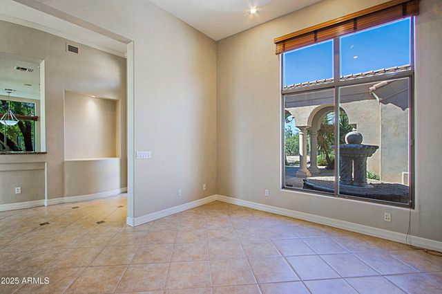 a view of a room with wooden floor and windows