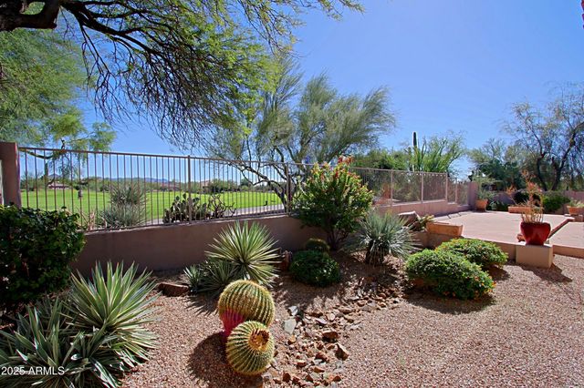 a view of a backyard with plants and outdoor seating