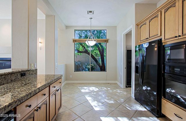 a view of a porch with furniture and a yard