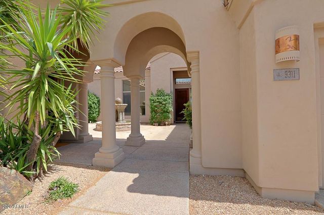 a view of hallway with a large mirror and a sink