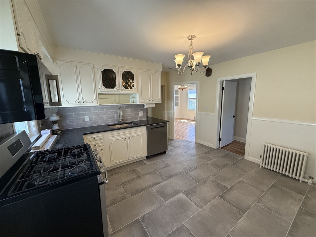 19 Chauncey Street, Unit 2 Watertown, MA 02472 - Photo 11 of 17 a kitchen with a stove a refrigerator and a sink