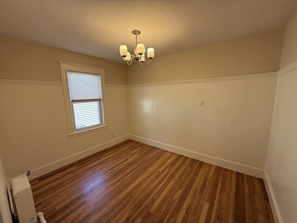 19 Chauncey Street, Unit 2 Watertown, MA 02472 - Photo 8 of 17 a view of empty room with wooden floor and fan
