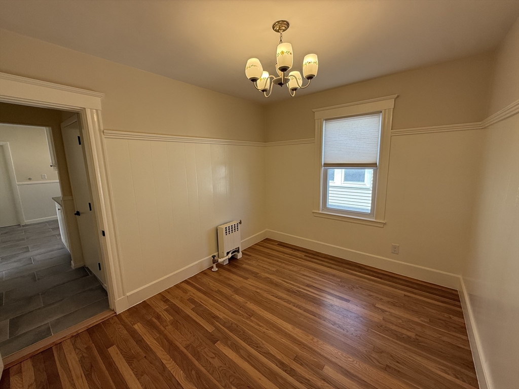 19 Chauncey Street, Unit 2 Watertown, MA 02472 - Photo 9 of 17 a view of a room with wooden floor and chandelier