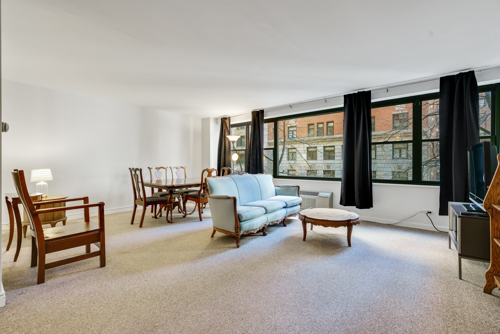 850 North Dewitt Place, Unit 4G Chicago, IL 60611 - Photo 5 of 12 a living room with furniture and floor to ceiling window