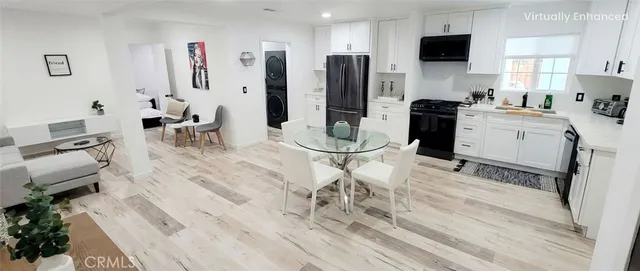 a kitchen with stainless steel appliances kitchen island granite countertop a refrigerator and microwave