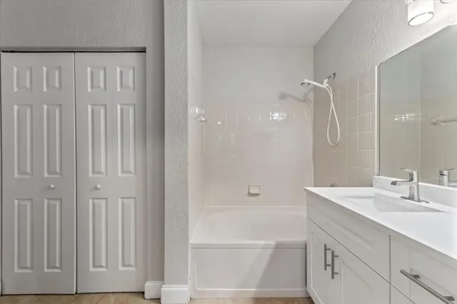 a bathroom with a shower a sink and a mirror