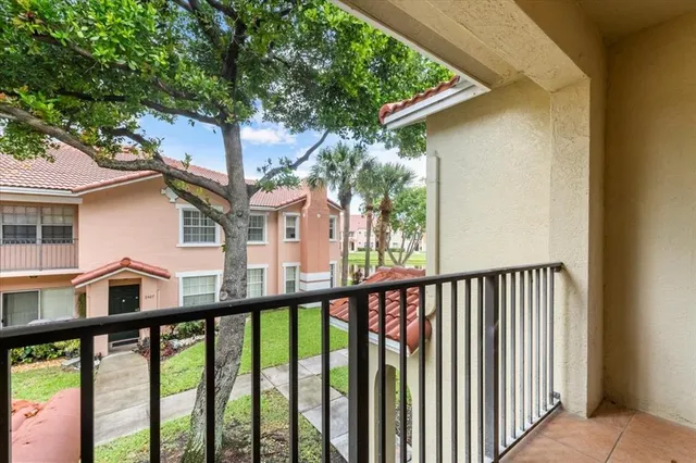 a view of a balcony with a tree
