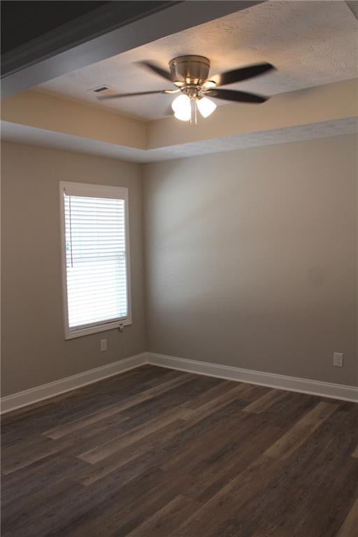 27 Parkman Road Phenix City, AL 36869 - Photo 9 of 11 Unfurnished room with baseboards, ceiling fan, and dark wood-style flooring