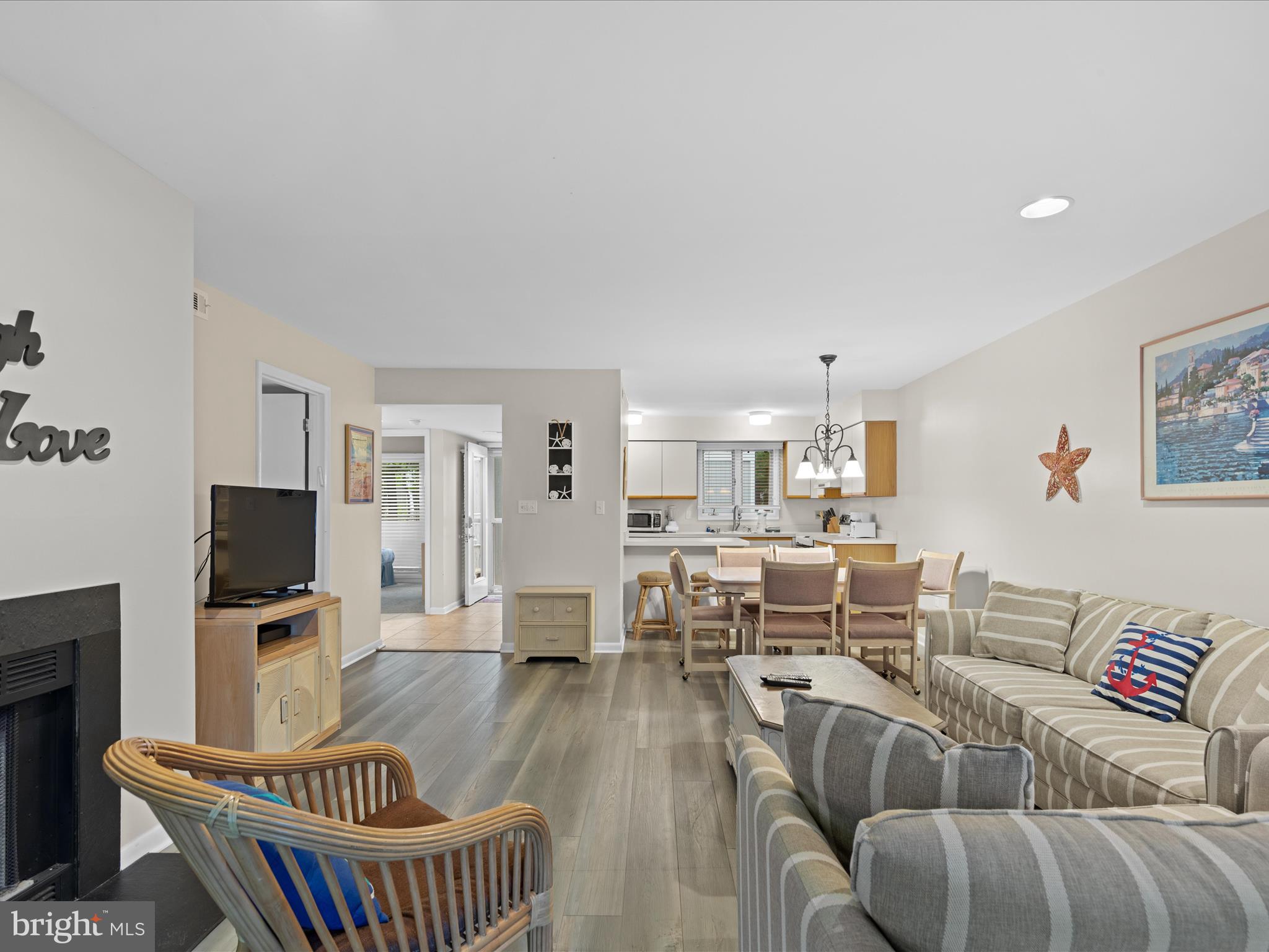 39346 Racquet Lane, Unit 8504 Bethany Beach, DE 19930 - Photo 18 of 40 a living room with furniture a flat screen tv and kitchen view