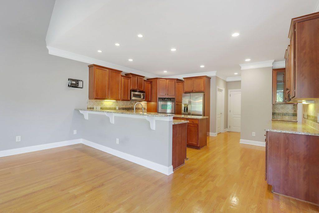 4174 Highglen Trace Northeast Dacula, GA 30019 - Photo 16 of 48 a kitchen with stainless steel appliances granite countertop a refrigerator a sink a stove and oven