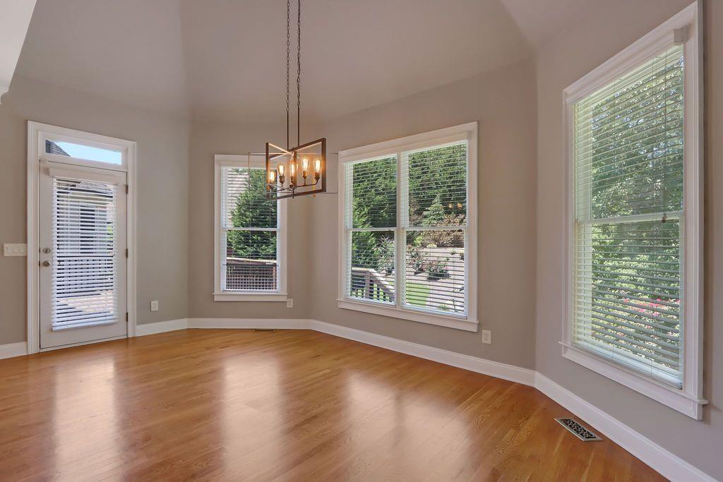 4174 Highglen Trace Northeast Dacula, GA 30019 - Photo 17 of 48 a view of an empty room with wooden floor and a window
