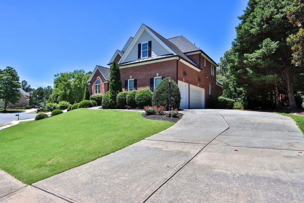 4174 Highglen Trace Northeast Dacula, GA 30019 - Photo 2 of 48 a front view of house with yard and green space
