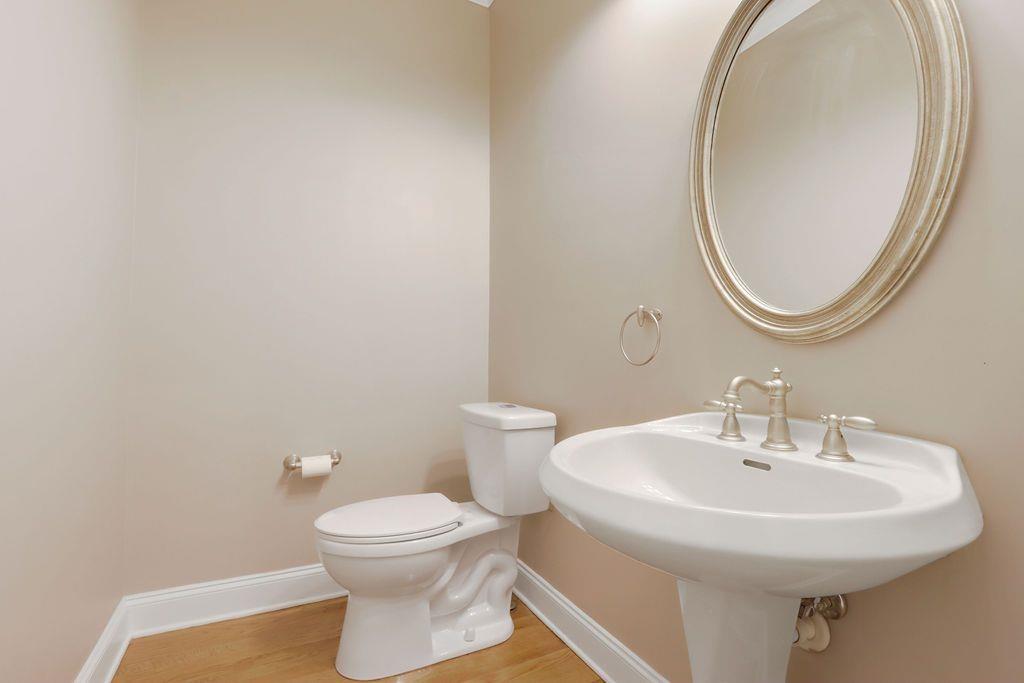 4174 Highglen Trace Northeast Dacula, GA 30019 - Photo 24 of 48 a bathroom with a toilet a sink and a mirror