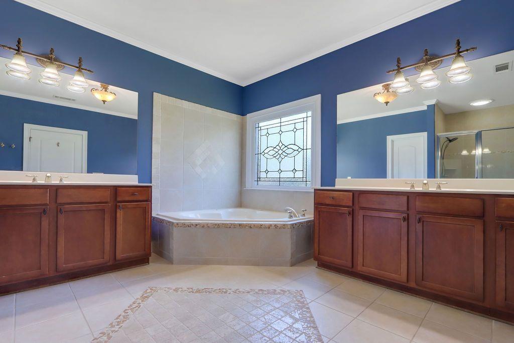 4174 Highglen Trace Northeast Dacula, GA 30019 - Photo 27 of 48 a spacious bathroom with a tub sink and mirror