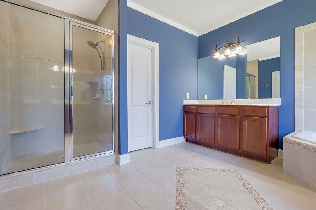 4174 Highglen Trace Northeast Dacula, GA 30019 - Photo 28 of 48 a bathroom with a double vanity sink mirror and shower