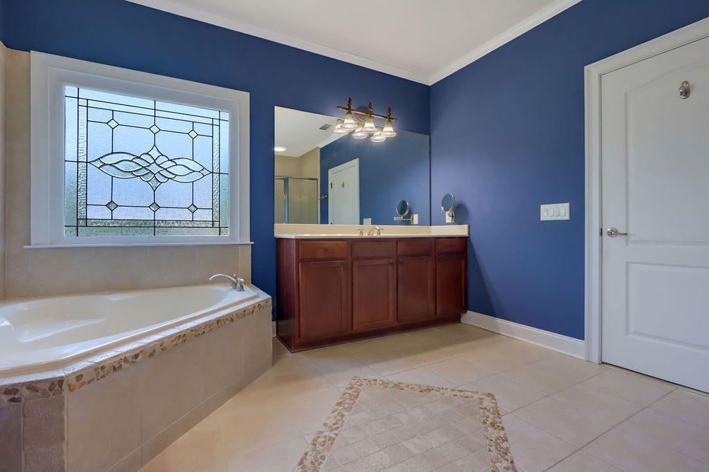 4174 Highglen Trace Northeast Dacula, GA 30019 - Photo 29 of 48 a bathroom with a tub sink and mirror