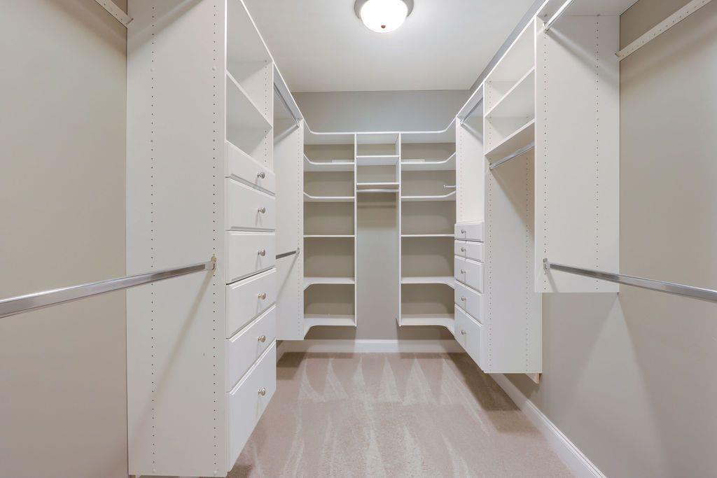 4174 Highglen Trace Northeast Dacula, GA 30019 - Photo 30 of 48 a view of walk in closet with empty racks