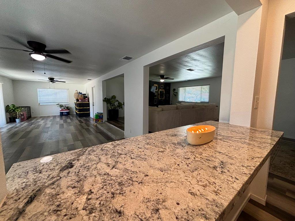 1237 De Cesari Avenue Madera, CA 93637 - Photo 13 of 33 a kitchen with kitchen island a sink appliances and living room view