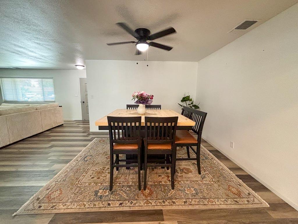 1237 De Cesari Avenue Madera, CA 93637 - Photo 17 of 33 a dining room with wooden floor and a rug