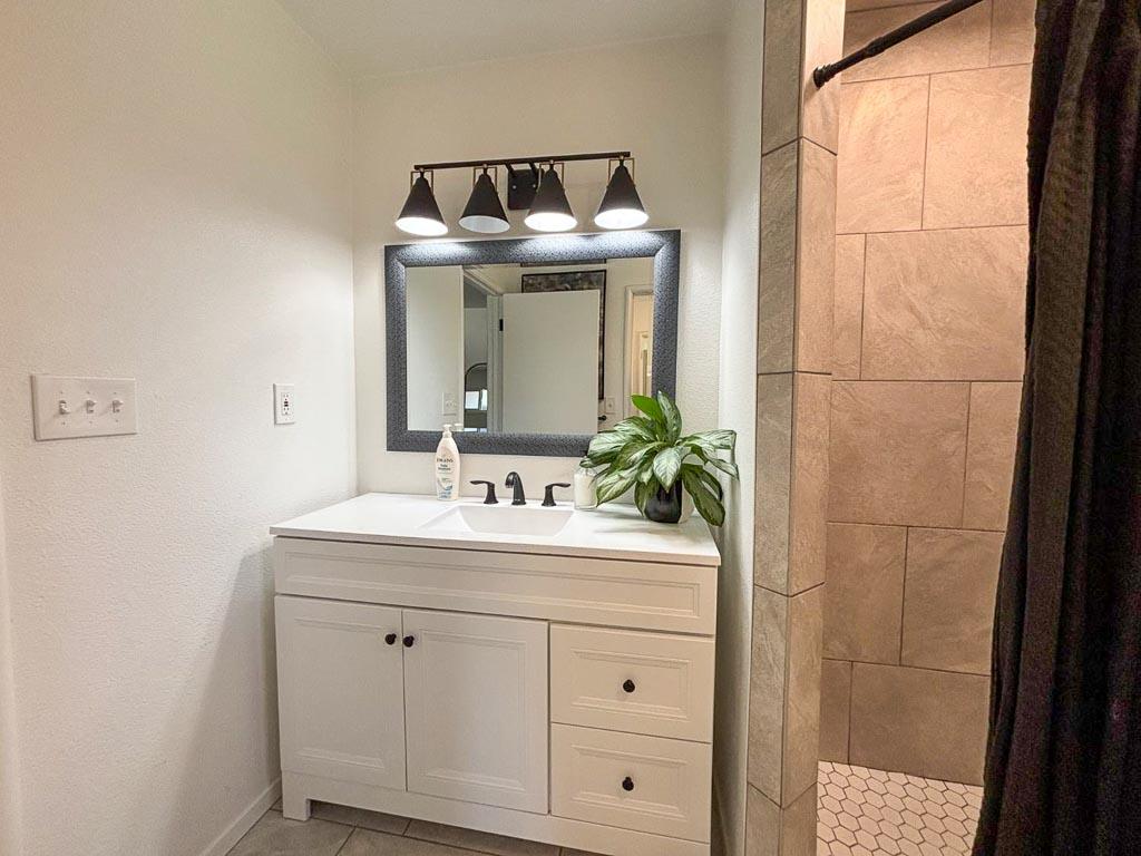 1237 De Cesari Avenue Madera, CA 93637 - Photo 20 of 33 a bathroom with a sink and a mirror