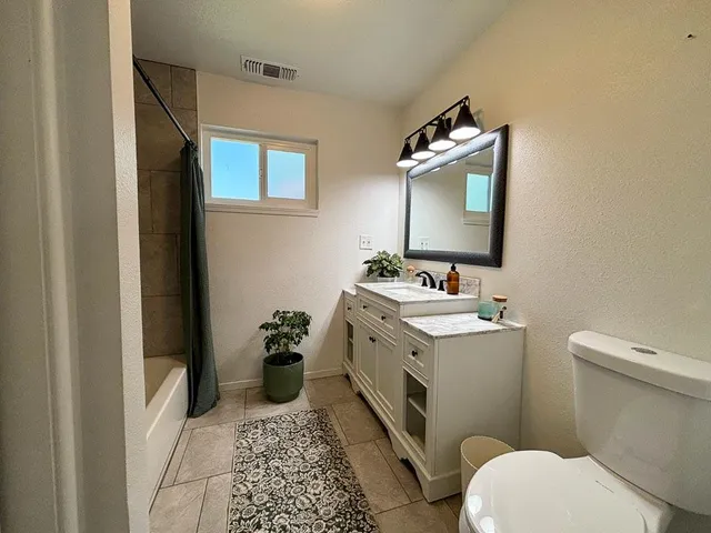 a bathroom with a tub and shower