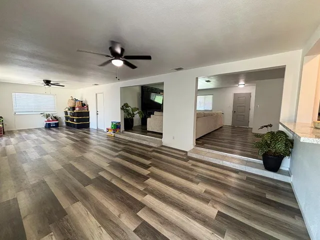 a view of entryway and hall with wooden floor