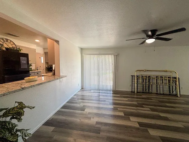 a view of a room with wooden floor gym equipment and a large window